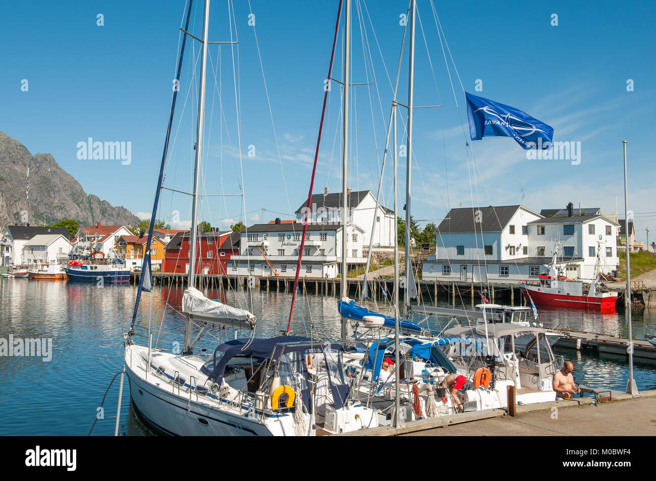 The harbor during summer in Henninsvaer. This is a popular tourist destination and a beautiful fishing village at Lofoten islands in northern Norway. Stock Photo