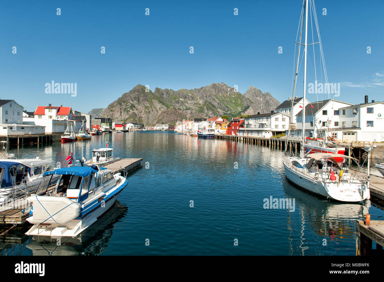 The harbor during summer in Henninsvaer. This is a popular tourist destination and a beautiful fishing village at Lofoten islands in northern Norway. Stock Photo