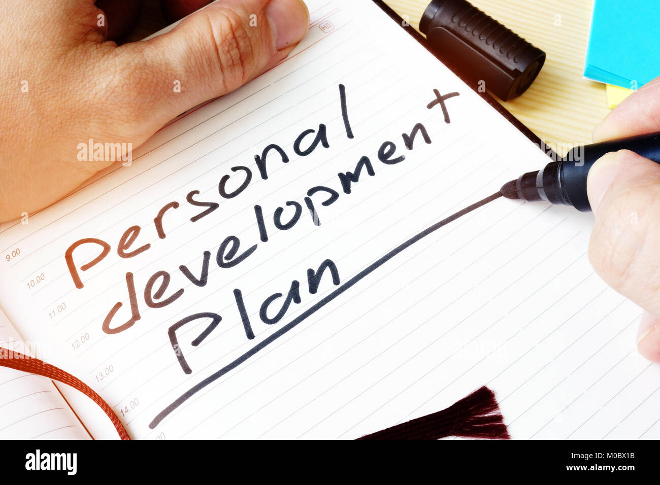 Man writing Personal development plan in a note Stock Photo Alamy