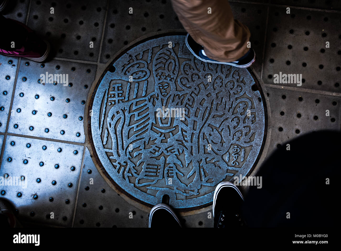 An illustrated manhole cover at the peak of Takaosan (Mount Takao), Hachioji, Tokyo, Japan Stock Photo