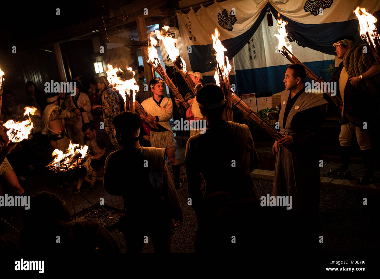 A group of men holding torches at Kurama fire festival, Japan Stock Photo