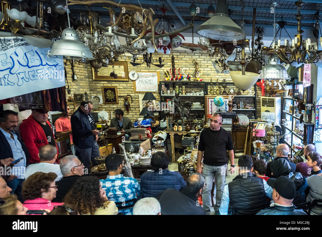 Unidentified man selling antique objects in auction shop in Balat,Istanbul,Turkey.15 October,2017 Stock Photo