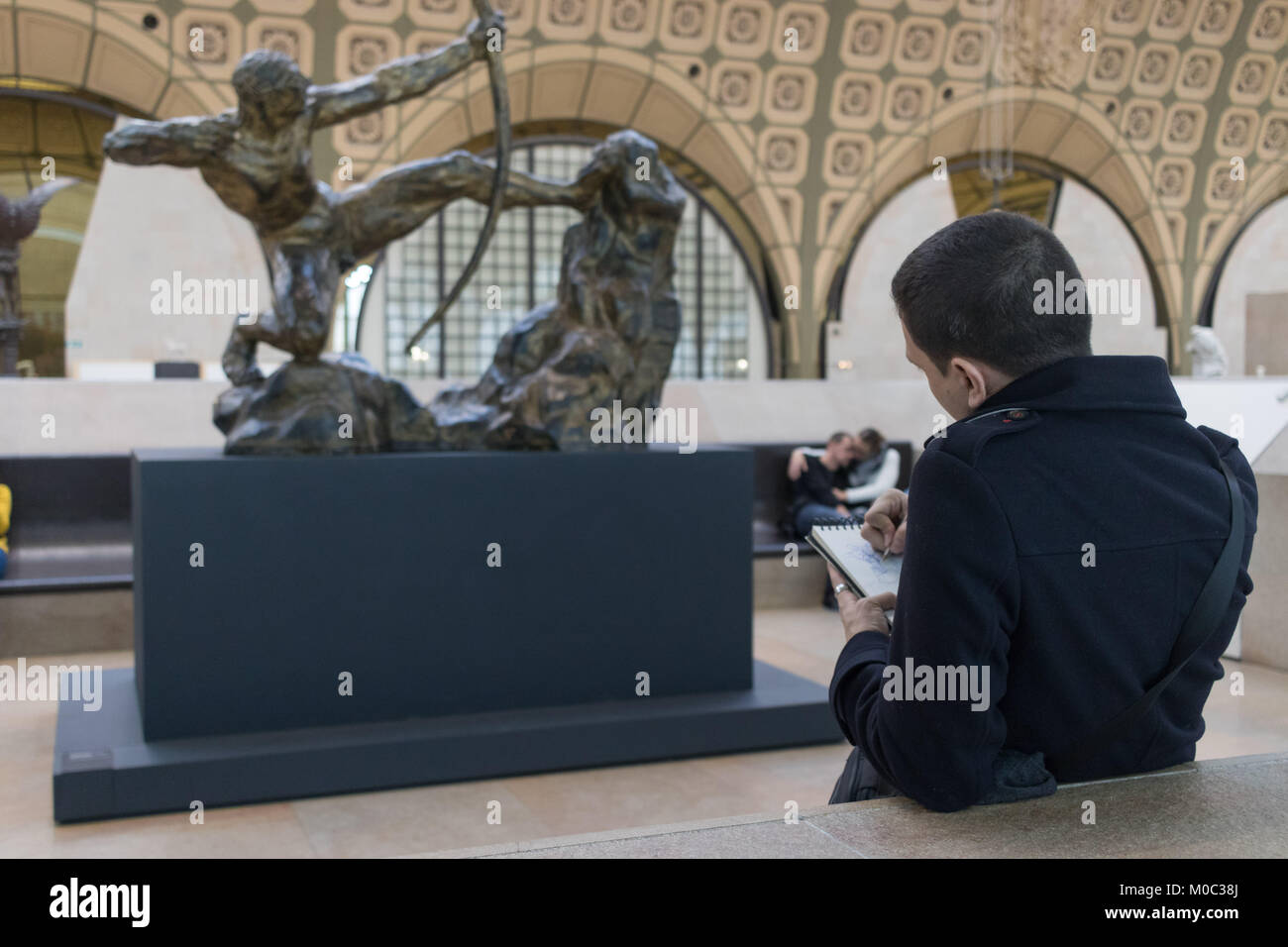 Man draws sculpture 'Hercules Killing the Birds of Lake Stymphalis' sculpted by Emile-Antoine Bourdelle in 1909 at Musée d'Orsay, Paris, December 2017 Stock Photo