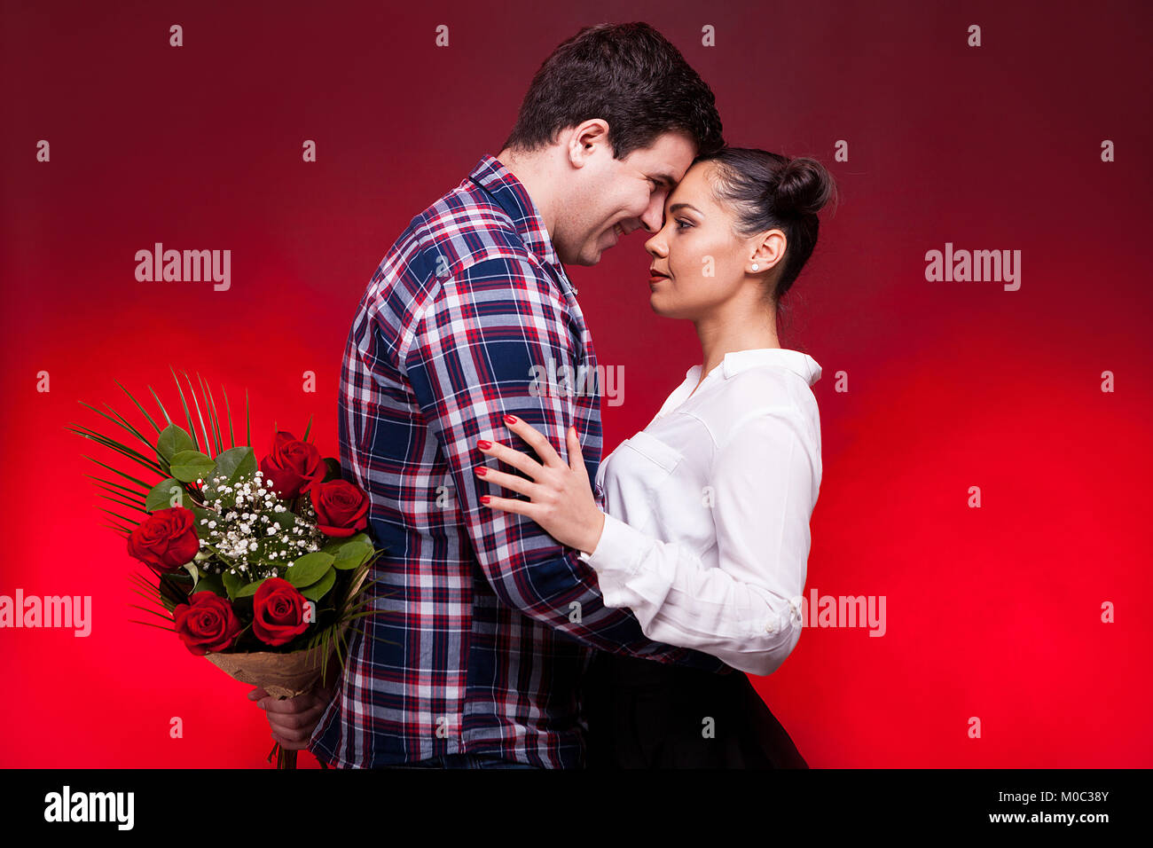 Man with a roses bouquet at his back on a first date Stock Photo - Alamy