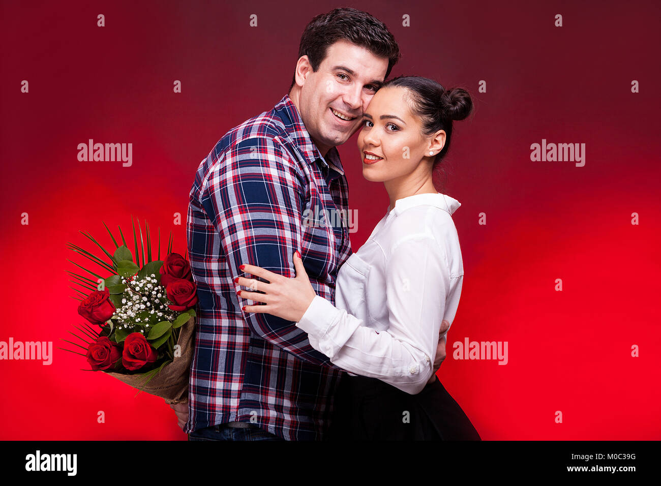 Man with a roses bouquet at his back on a first date Stock Photo - Alamy