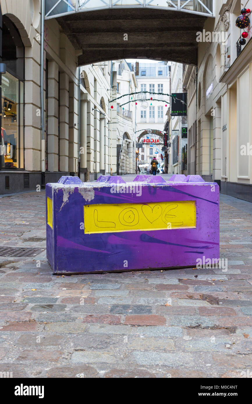 Concrete barrier with 'Love' painted on it in a shopping street in Lille, France Stock Photo