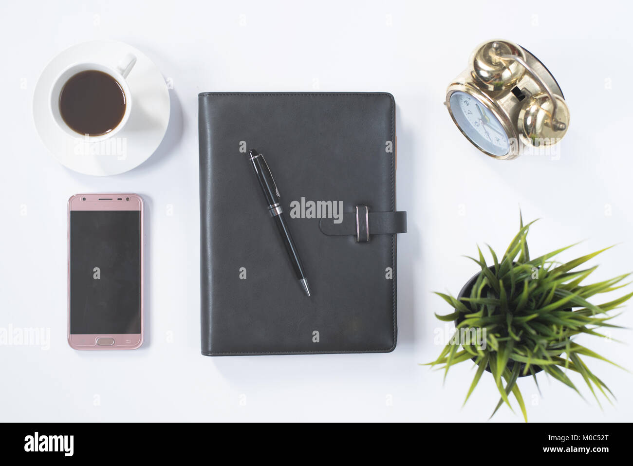 notebook,phone,clock and coffee on white flat lay. journalist workspace concept Stock Photo