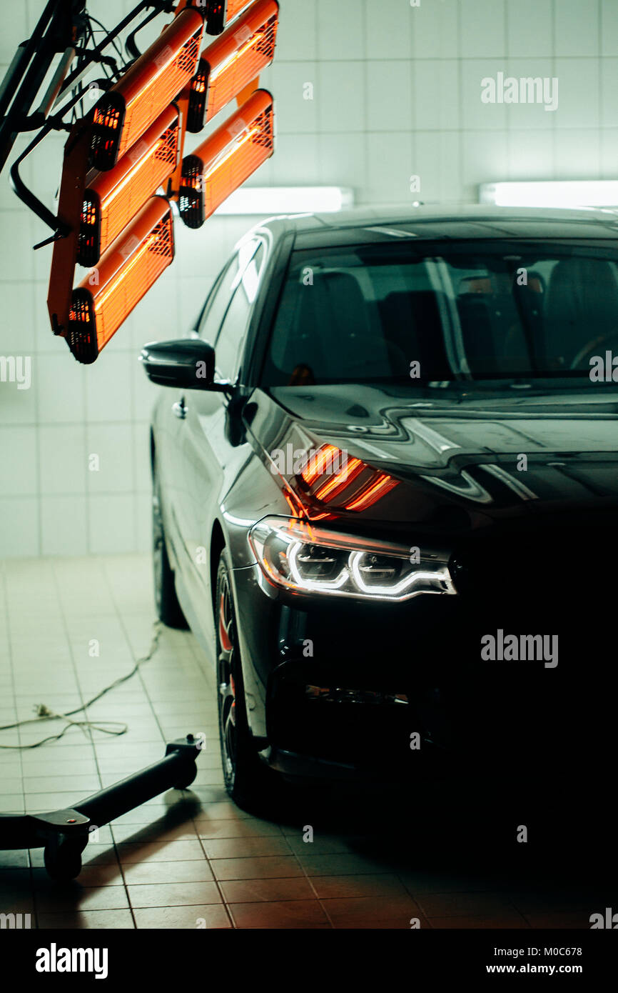 lamps for drying the ceramic coating are behind car Stock Photo Alamy