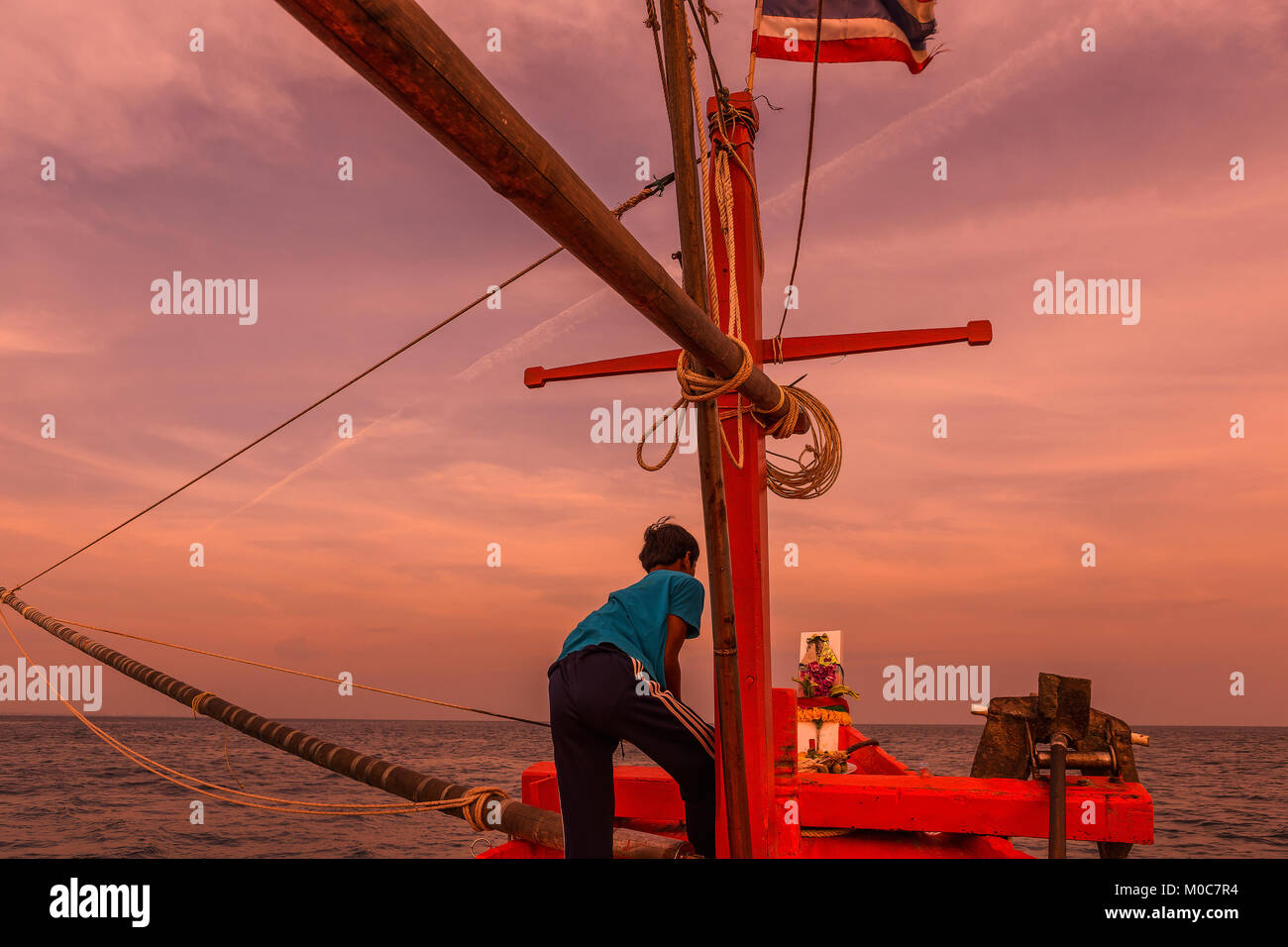 fisherman working with fishing rod on the fisherman boat on the sea Stock Photo