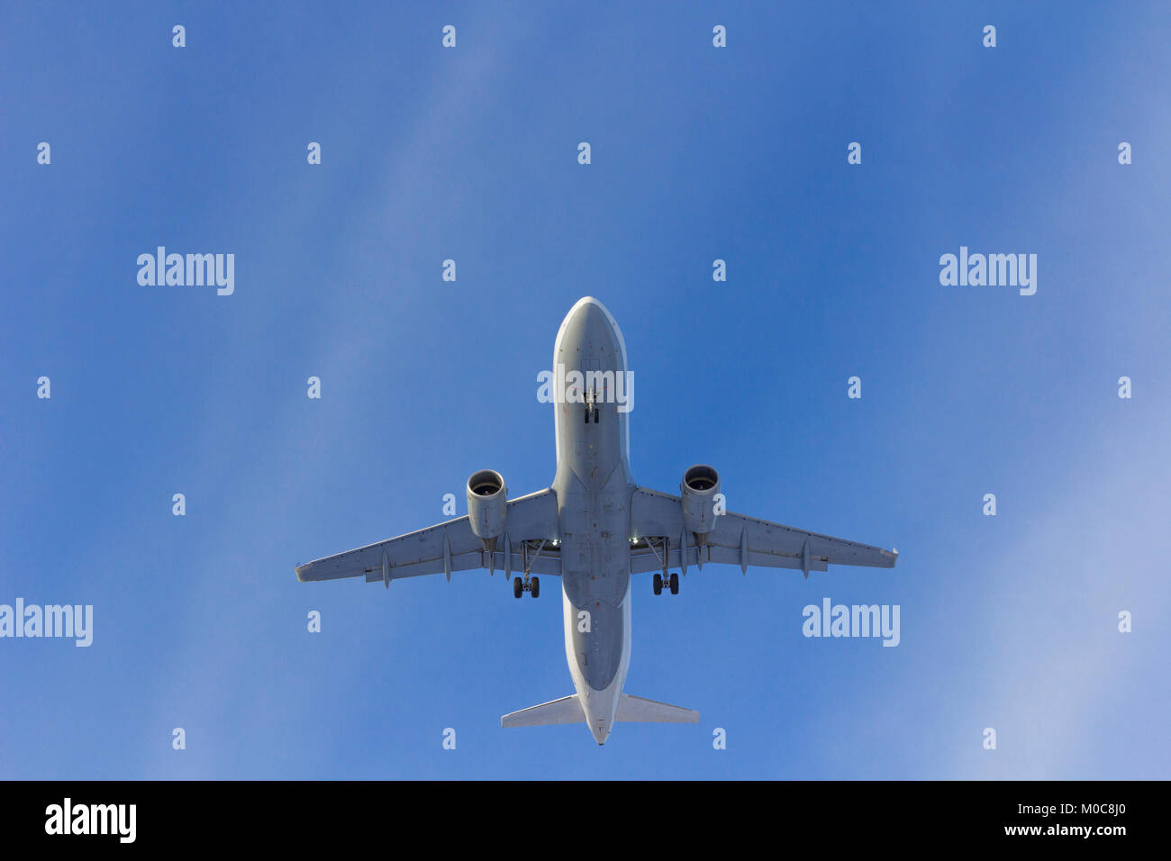 Airplane flies against a background of white clouds Stock Photo - Alamy