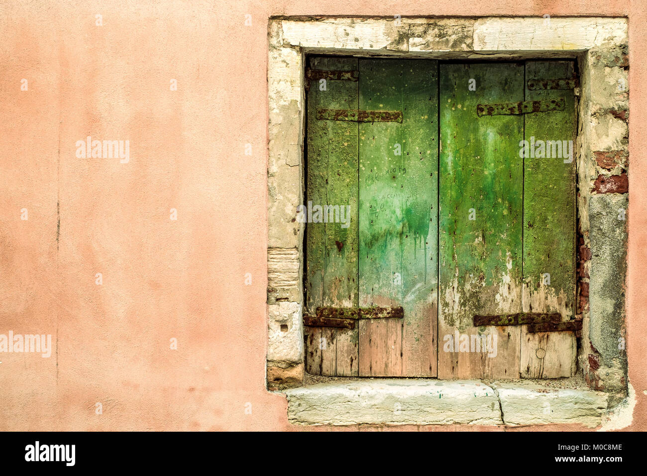 square  weathered closed window in Venice, Italy. Stock Photo