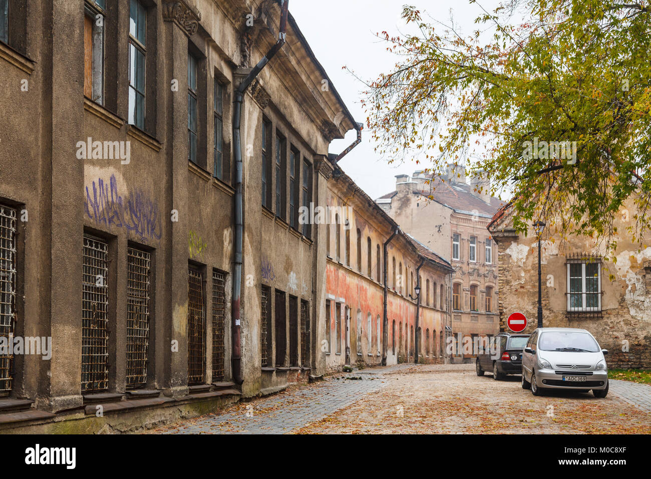 Dilapidated, run-down side street of empty old terraced houses with crumbling brickwork in Vilnius Old Town, capital city of Lithuania, eastern Europe Stock Photo