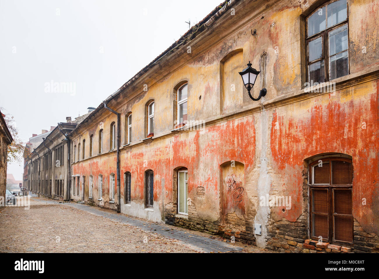 Dilapidated, run-down side street of empty old terraced houses with crumbling brickwork in Vilnius Old Town, capital city of Lithuania, eastern Europe Stock Photo