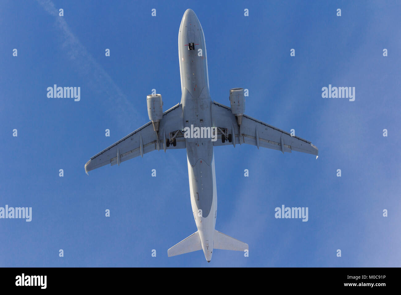 Airplane flies against a background of white clouds Stock Photo - Alamy