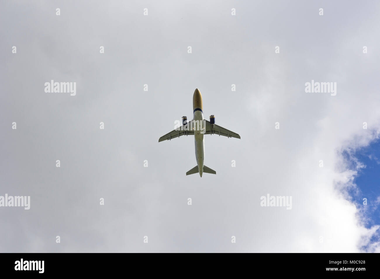 Airplane flies against a background of white clouds Stock Photo - Alamy