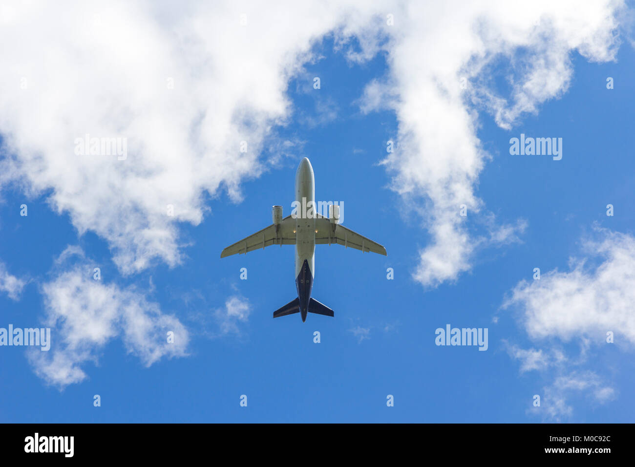 Airplane flies against a background of white clouds Stock Photo - Alamy