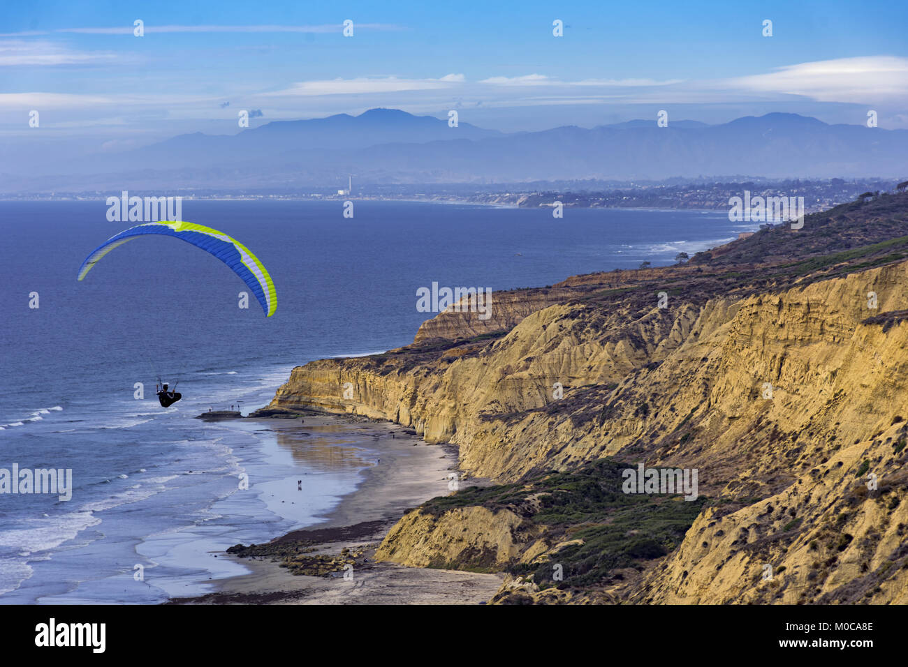 Hang glider soaring at Torrey Pines hang glider port along the coast at La Jolla California USA Stock Photo