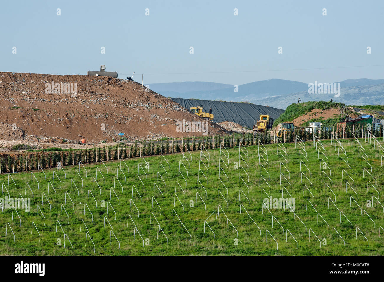 Rubbish dump and unfinished photovoltaic field Stock Photo