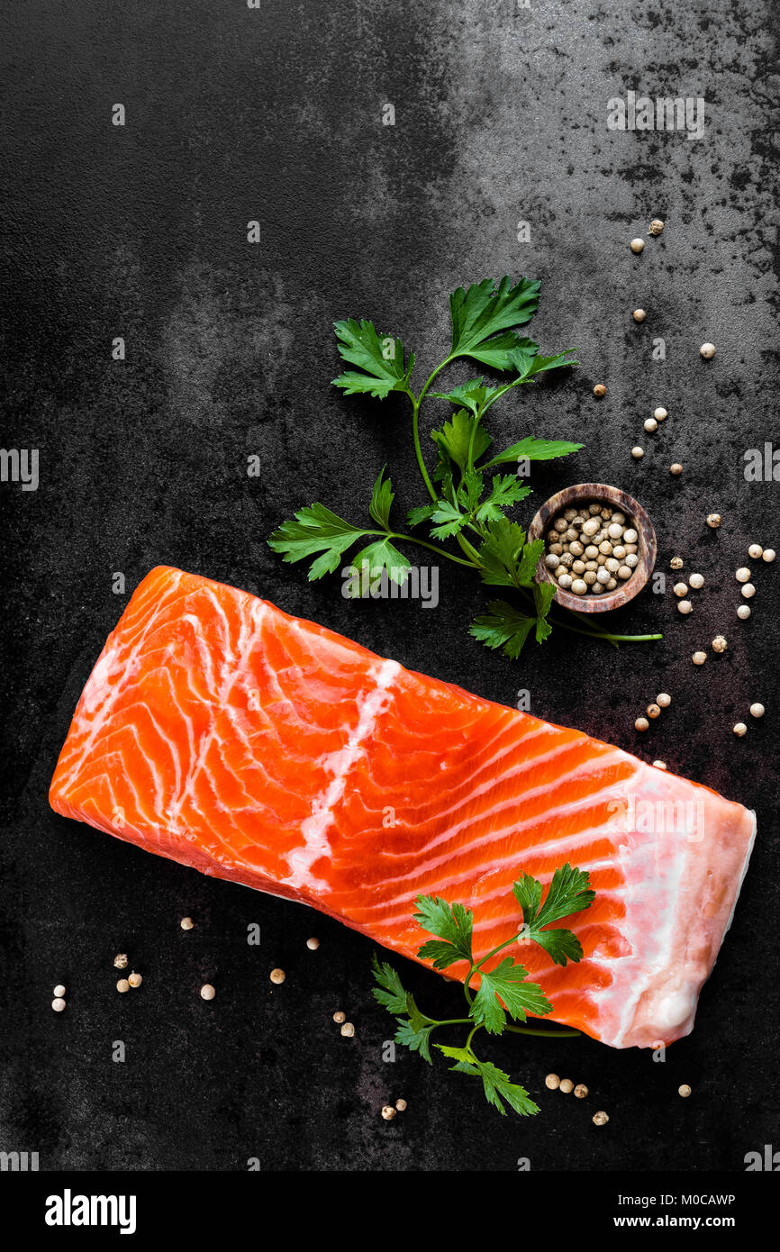 Fresh salmon fish fillet on black background, top view Stock Photo - Alamy