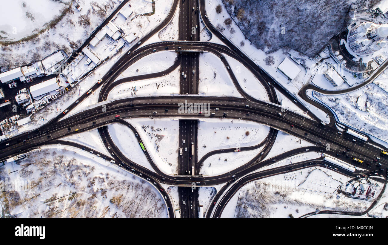 Aerial view of a turbine road interchange in Kiev. Aerial Drone Flight View of freeway busy city rush hour heavy traffic jam highway. Top view. Stock Photo