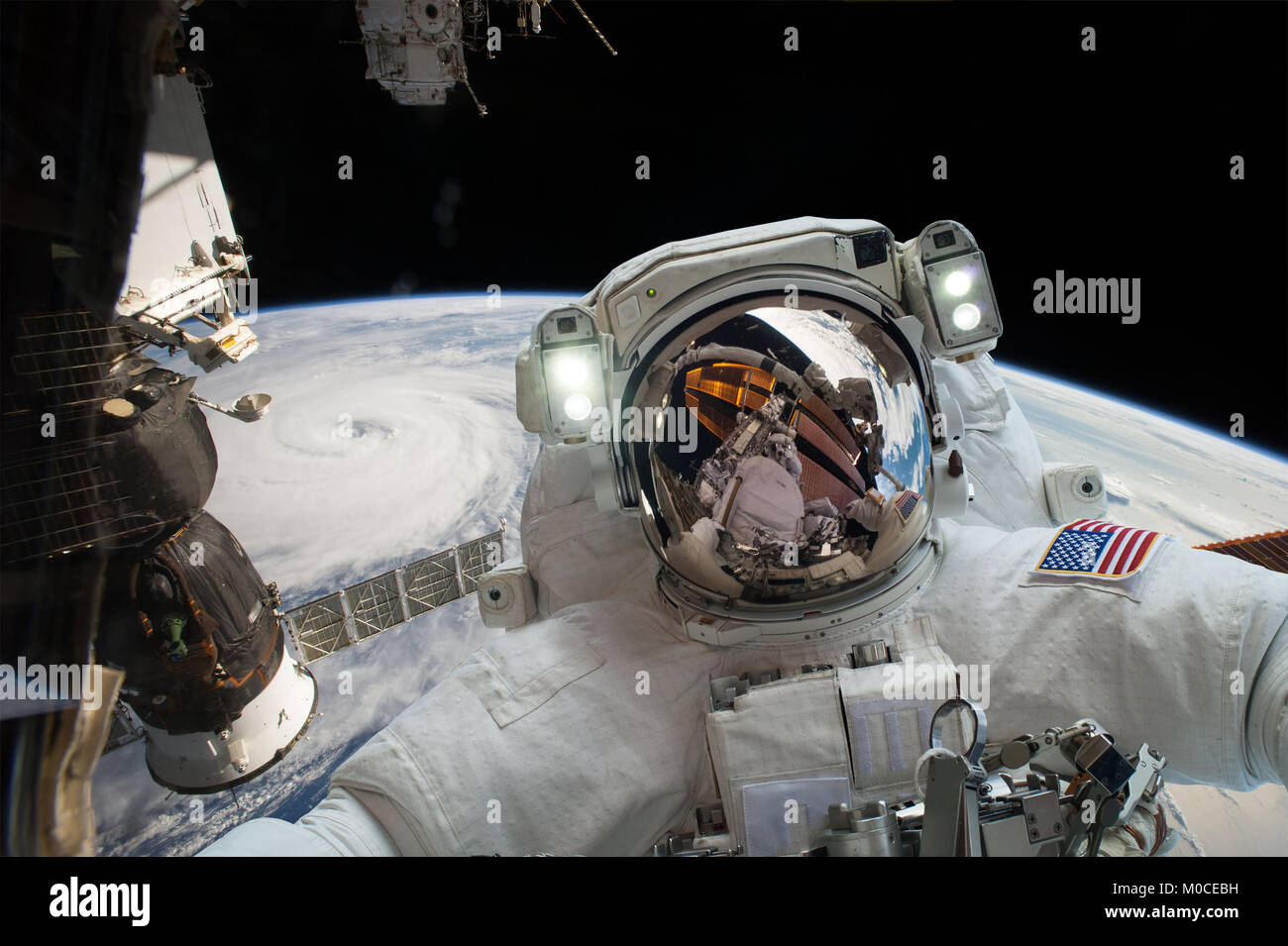 Astronaut in outer space against the backdrop of the planet earth. Elements of this image furnished by NASA. Stock Photo