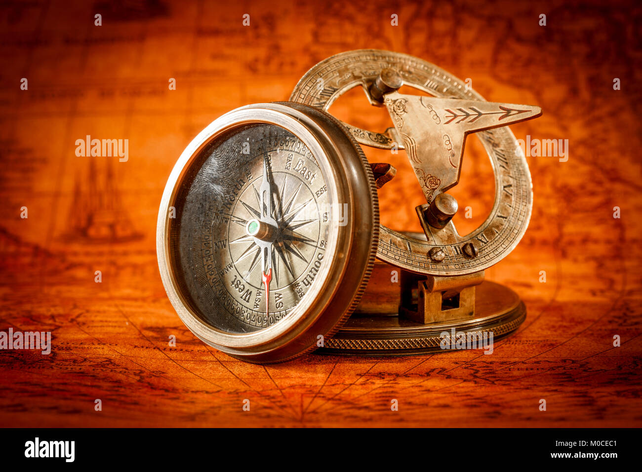Vintage still life. Vintage compass lies on an ancient world map in 1565. Stock Photo