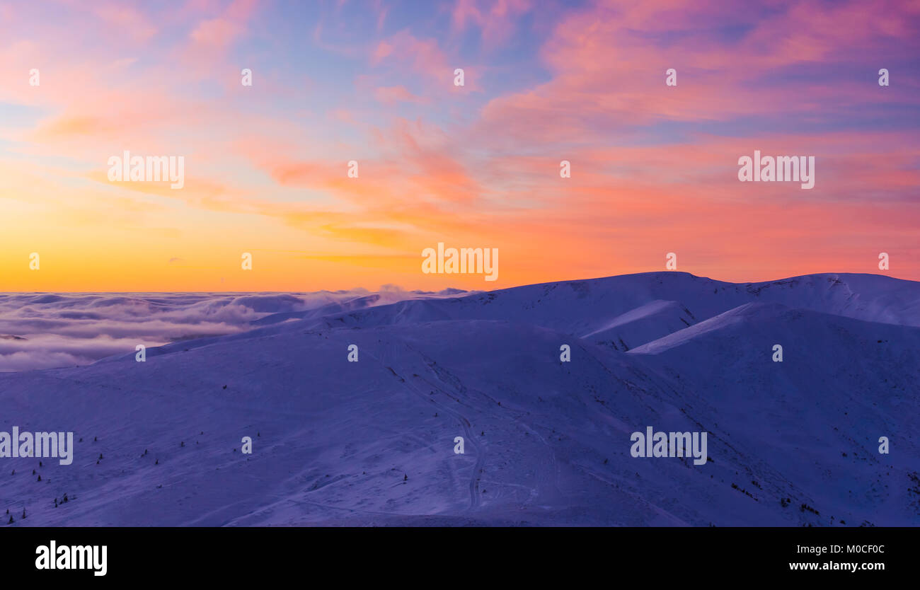 Amazing sunset over cloudy mountains Stock Photo - Alamy