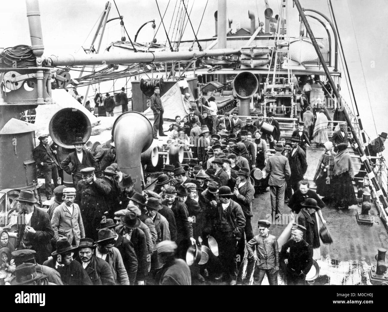 Trans-Atlantic European emigrants en-route to North America queuing on the deck of the Hamburg-America Line’s 'Graf Waldersee' c.1900 Stock Photo