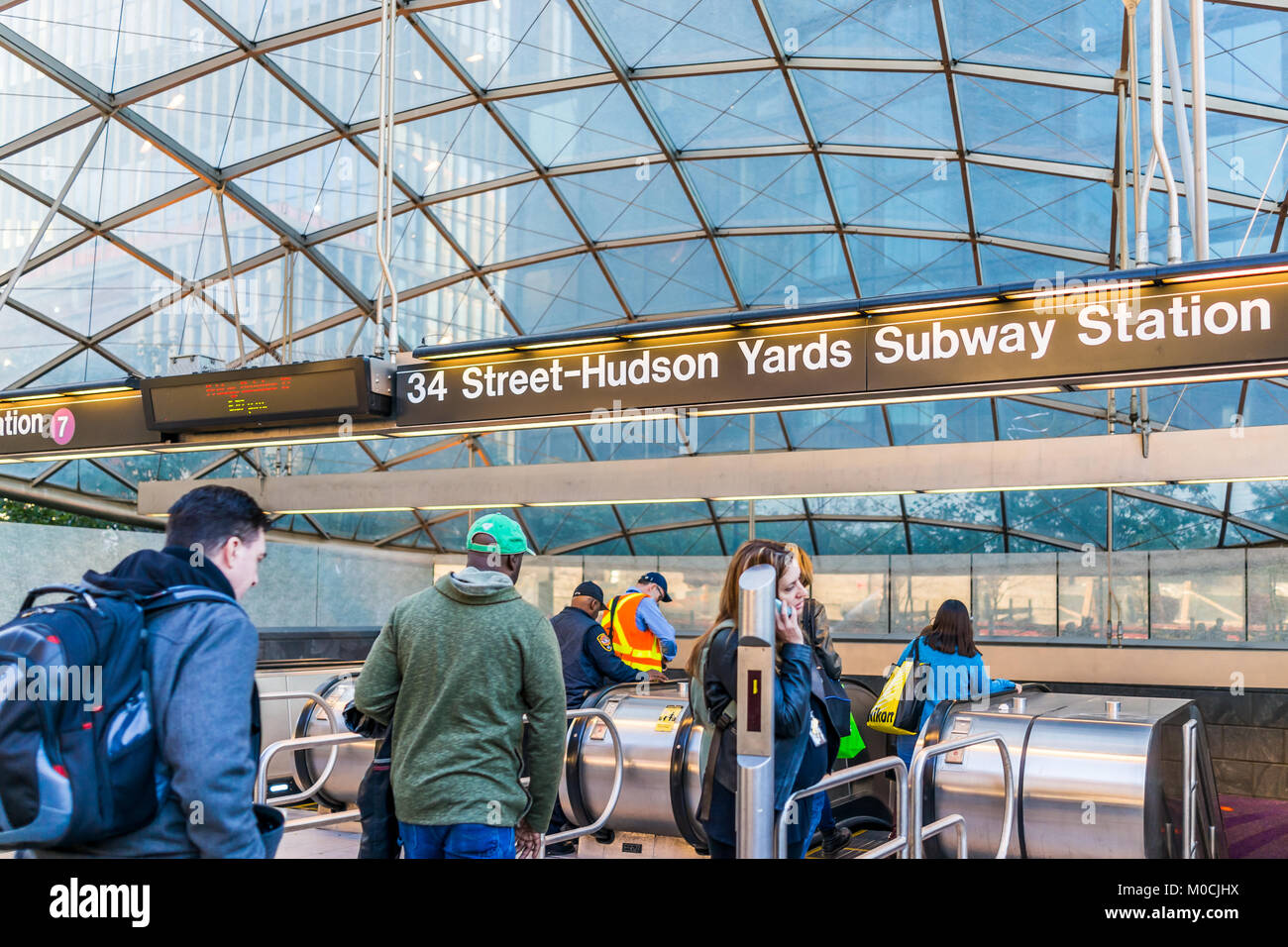 New York City, USA - October 27, 2017: People entering transit by sign in NYC Chelsea West Side 34th Street Hudson Yards Subway Station after work on  Stock Photo