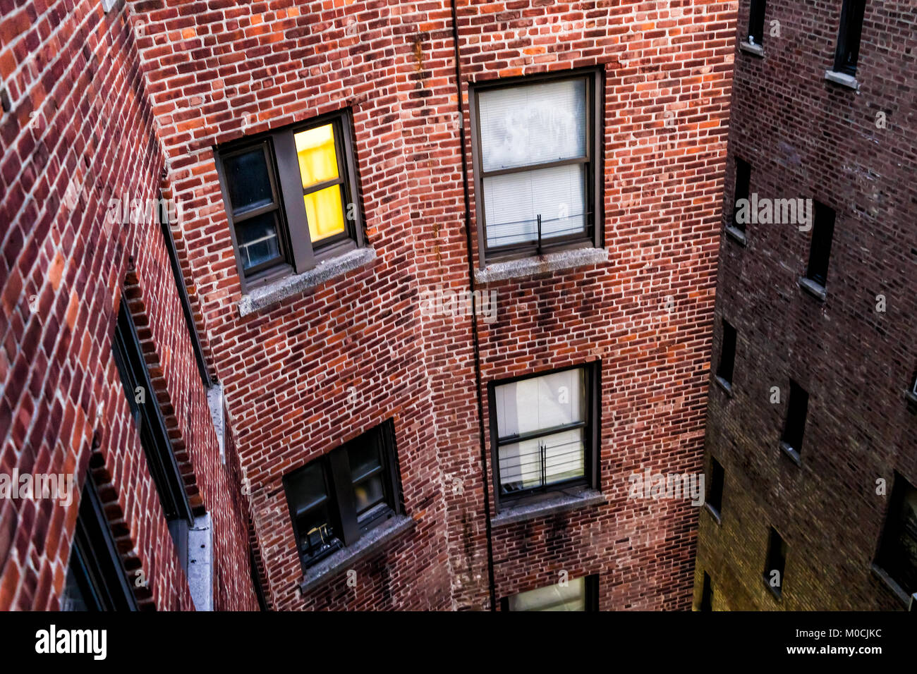 Illuminated brick apartment condo building architecture in Fordham