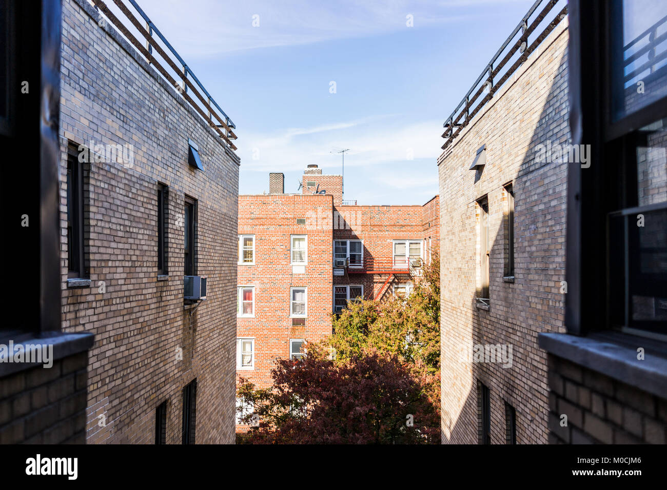 Residential apartment building and street road with sidewalk between in
