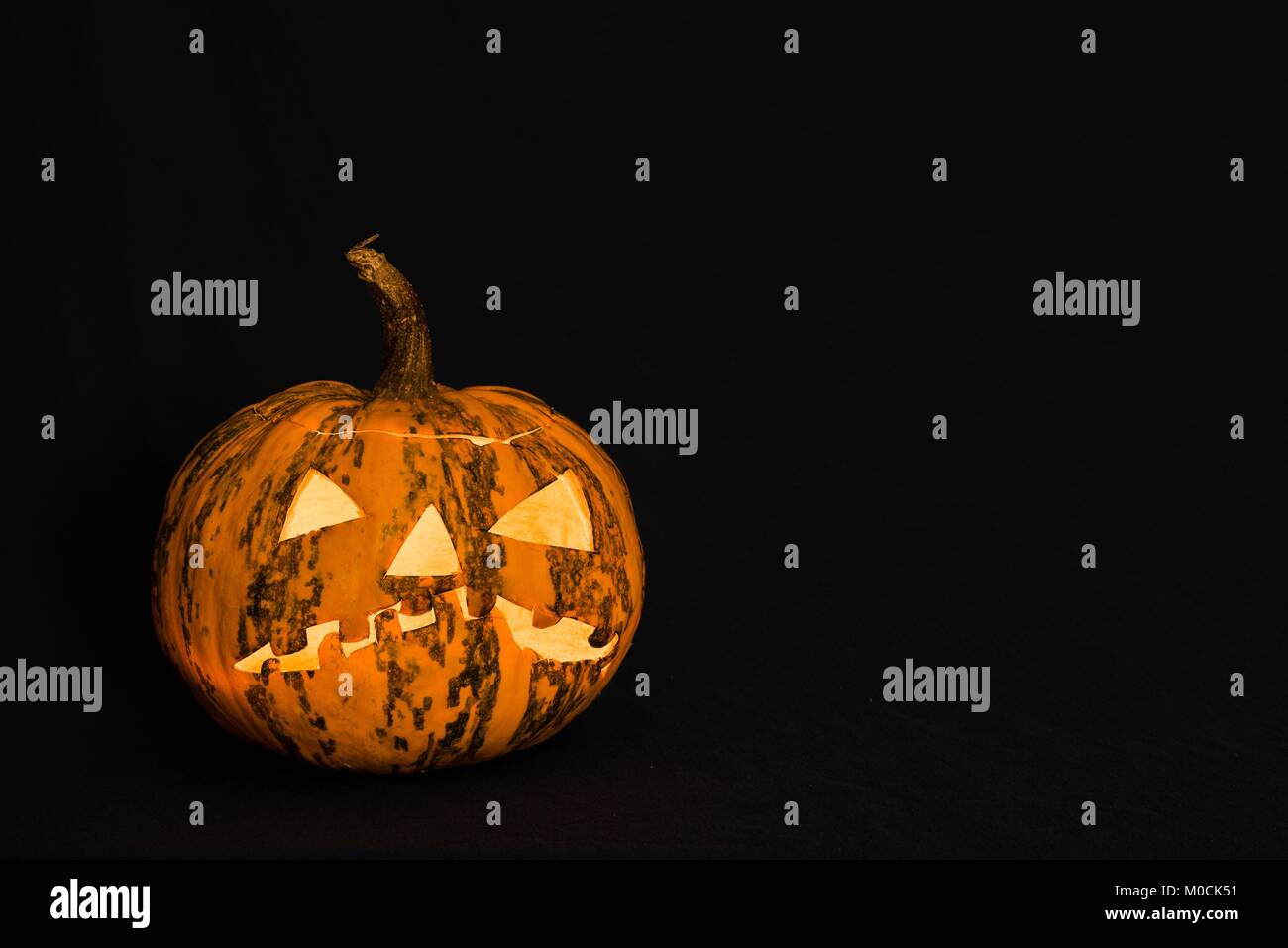 Halloween pumpkin in front of black background Stock Photo - Alamy