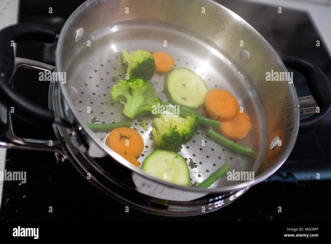 Healthy cooking steamed vegetables of cauliflower , broccoli and courgette Stock Photo