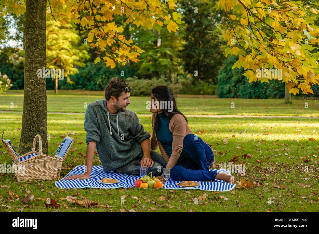 Happy couple having a picnic in the park at the Veluwe netherlands
