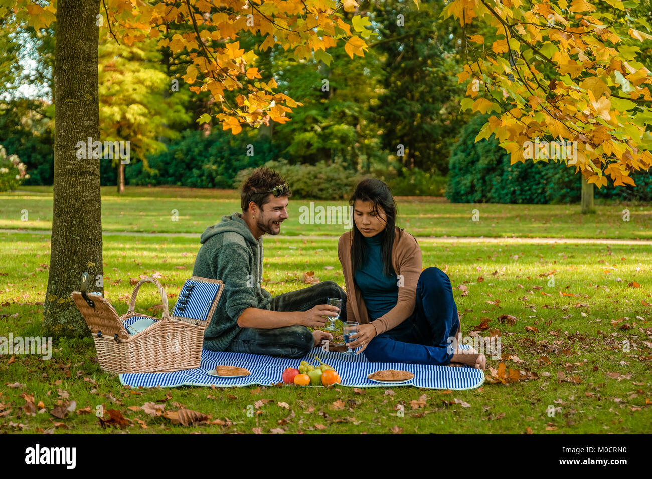 Happy couple having a picnic in the park at the Veluwe netherlands