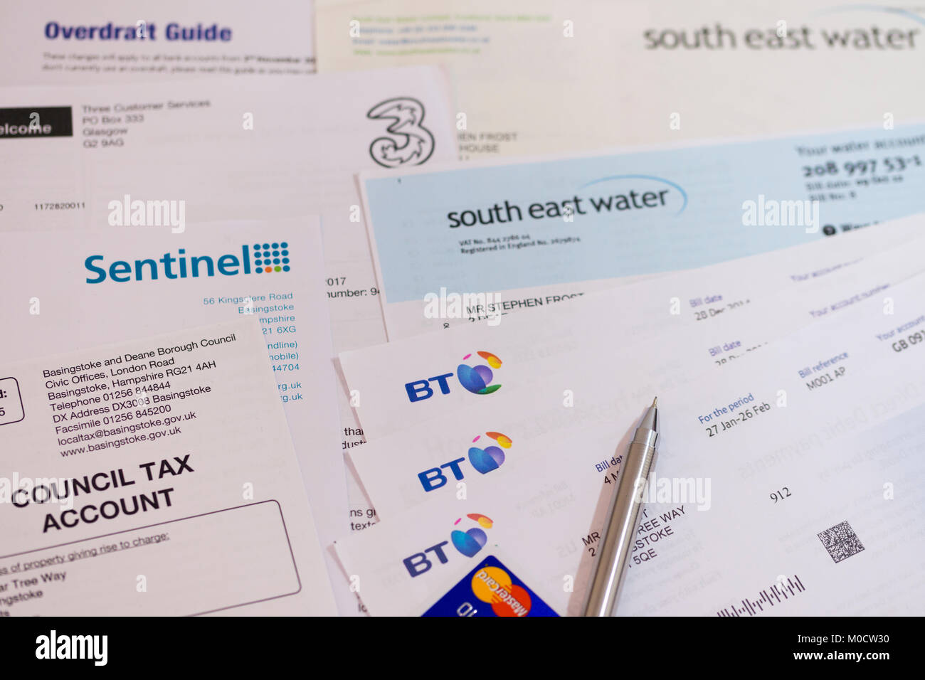 A selection of bills, a credit card and a guide to overdrafts Stock