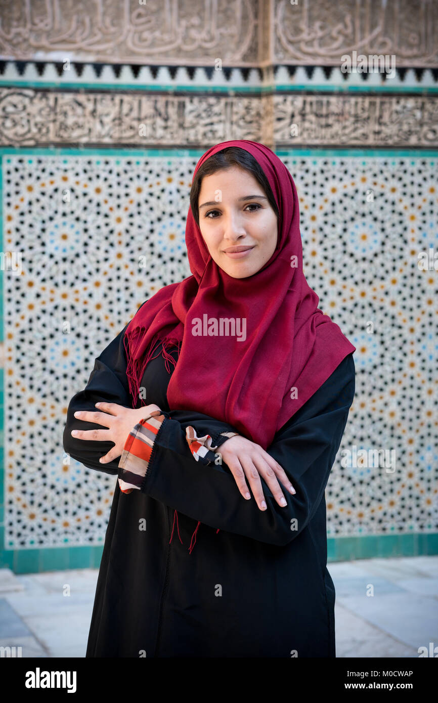 Arab woman in traditional clothing with red hijab in traditional ambient Stock Photo
