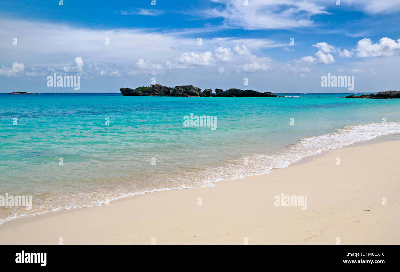 Bermuda white sand beach with turquoise sea water in Long Bay, Copper's Island Nature Reserve, under blue sky and white clouds Stock Photo
