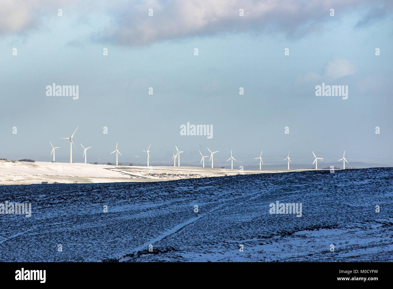 Row of wind turbines producing green energy near Calecotes on the Pennine hills in northern England, UK Stock Photo
