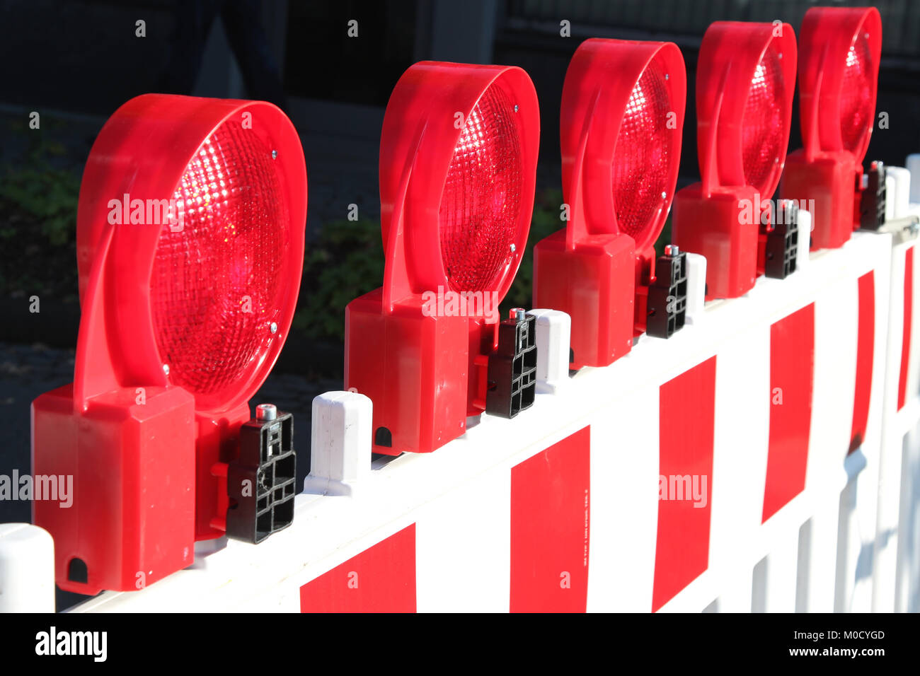 mobile traffic barrier with red warning lights at construction site Stock Photo