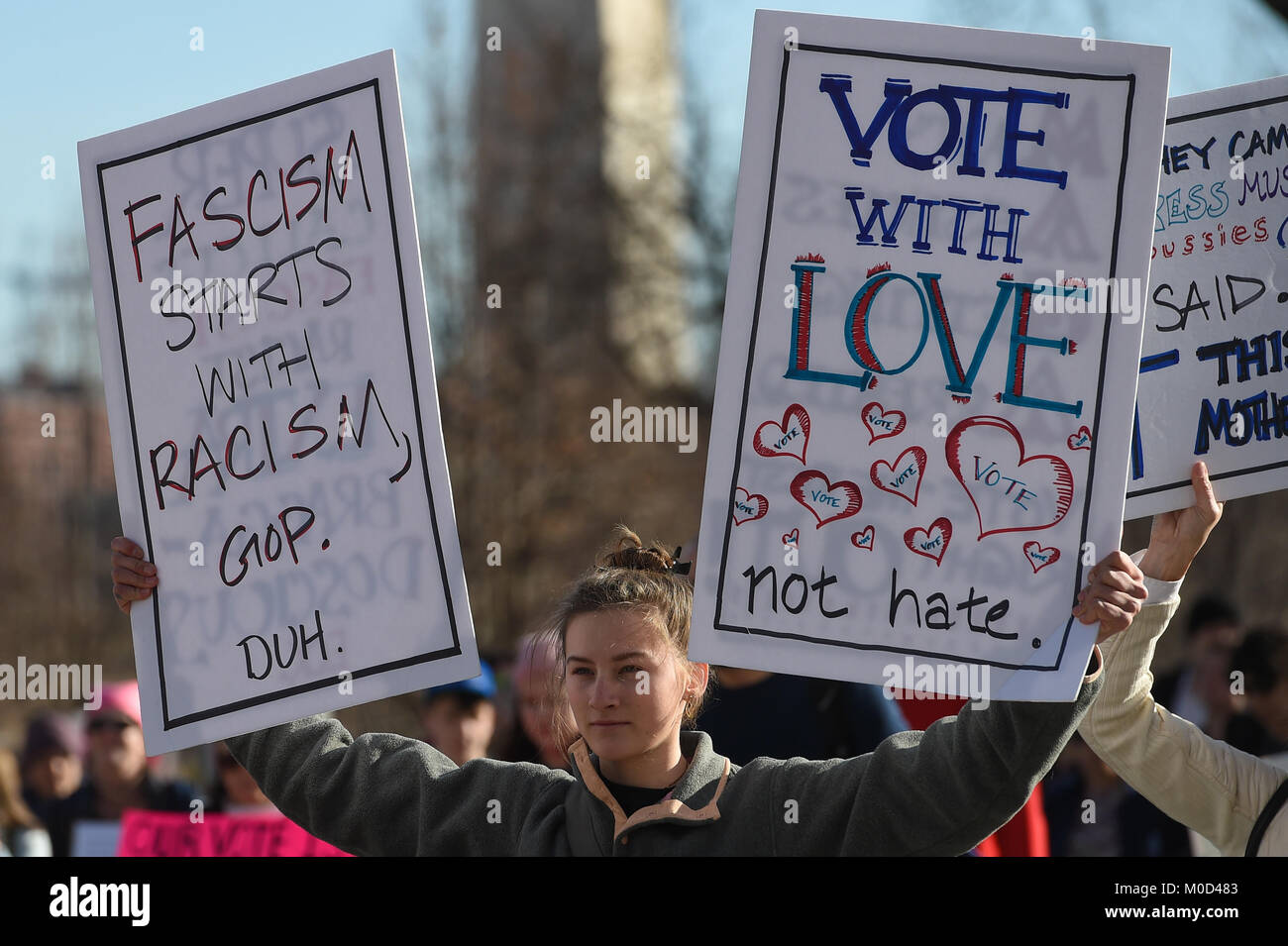Washington DC, USA. 20th Jan, 2018. Jan. 20th Jan, 2018. A young woman holds two signs up as she walks toward the White House during the Women's March in Washington, DC, on Jan. 20, 2018 in Washington Credit: csm/Alamy Live News Credit: Cal Sport Media/Alamy Live News Stock Photo