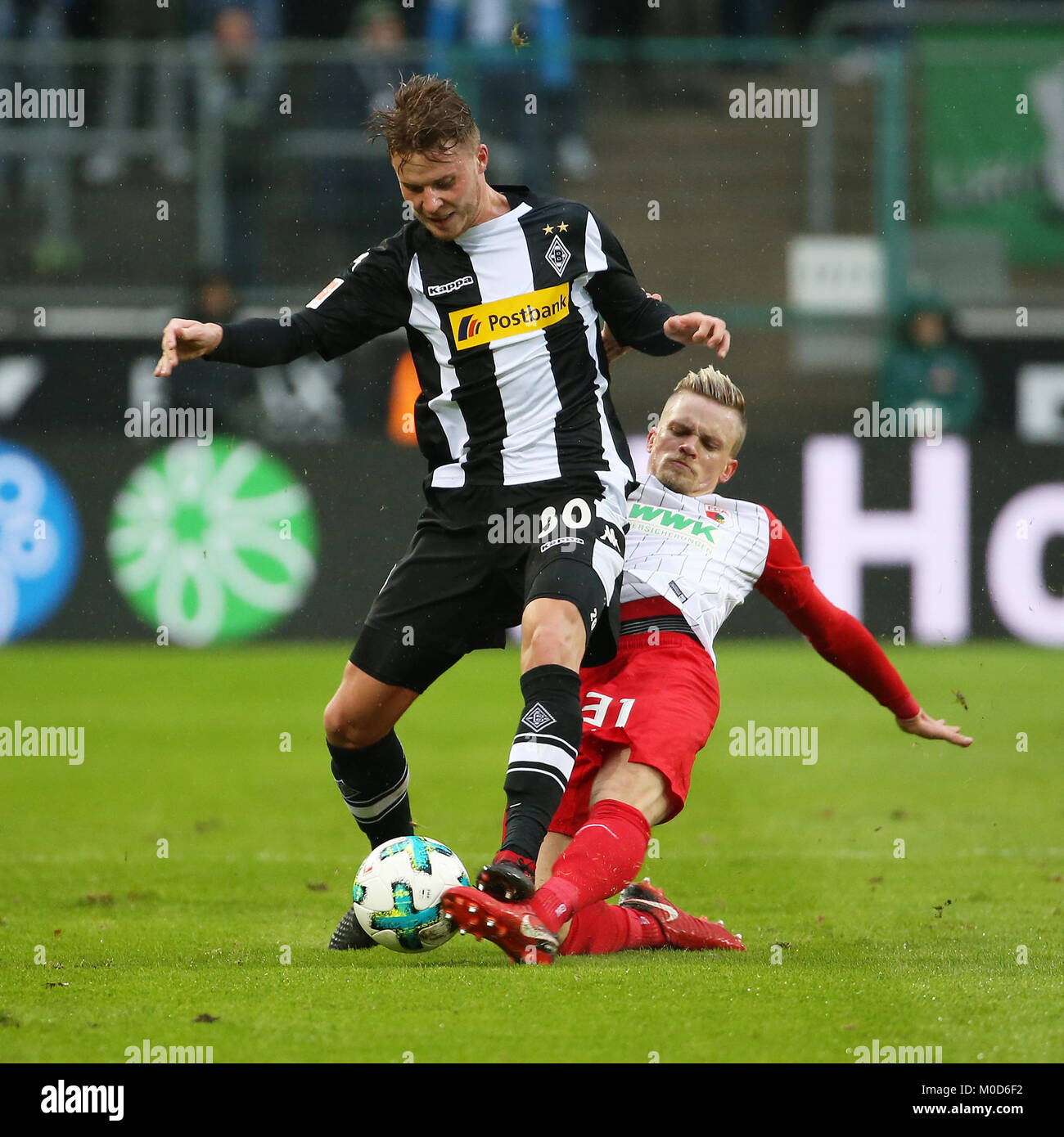 Moenchengladbach, Germany. 20th Jan, 2018. Philipp Max of Augsburg (R) vies with Nico Elvedi of Moenchengladbach during the Bundesliga match between Borussia Moenchengladbach and FC Augsburg in Moenchengladbach, Germany, on Jan. 20, 2018. Moenchengladbach won 2-0. Credit: Ulrich Hufnagel/Xinhua/Alamy Live News Stock Photo