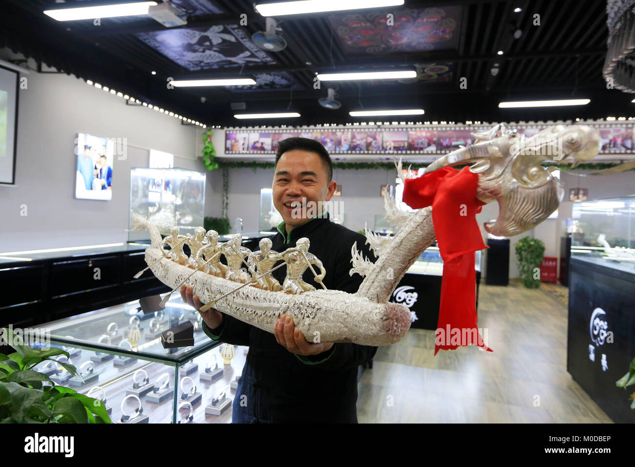Qiandongnan, China's Guizhou Province. 20th Jan, 2018. A villager shows a silver dragon he made in Danzhai County, southwest China's Guizhou Province, Jan. 20, 2018. Intangible cultural heritages are moved into experiencing houses in scenic spots of Danzhai county, in which tourists can get to know the local culture in a much more personal way. The measure has brought considerable increases to the income of local tourism and the poor. Credit: Wu Jibin/Xinhua/Alamy Live News Stock Photo