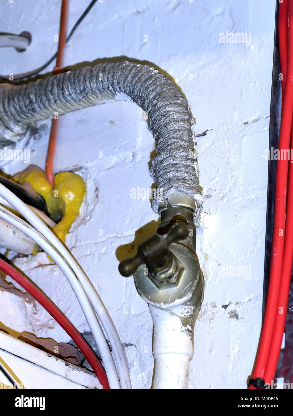Asbestos rope insulation around a water pipe Stock Photo - Alamy