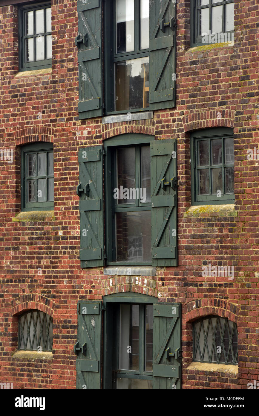 an old warehouse on the river medina at Newport harbour or quay on the isle of wight now converted into luxury flats and apartments. riverside living. Stock Photo