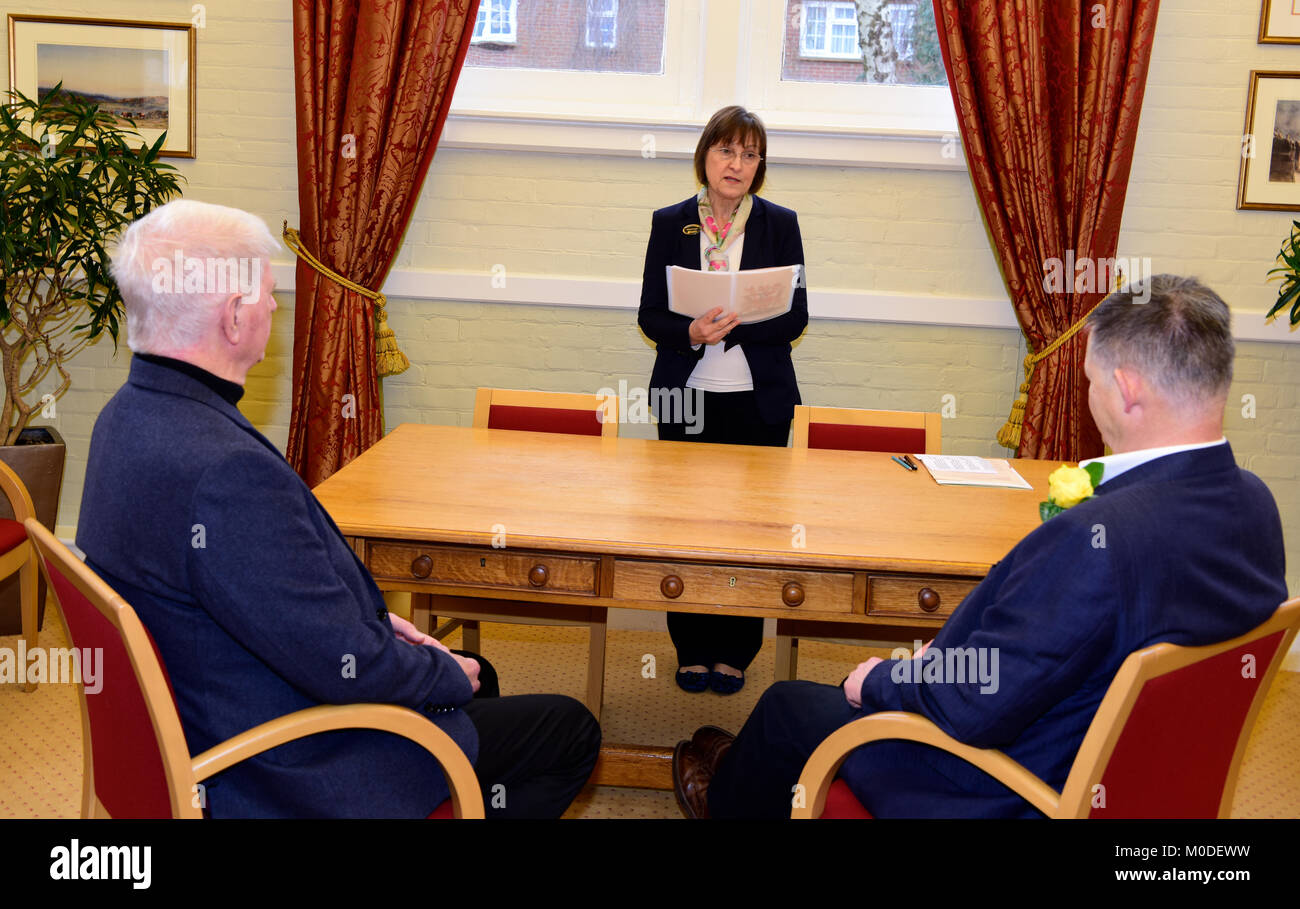 Registrar at work conducting a civil partnership ceremony for male couple, Alton, Hampshire, UK. Stock Photo