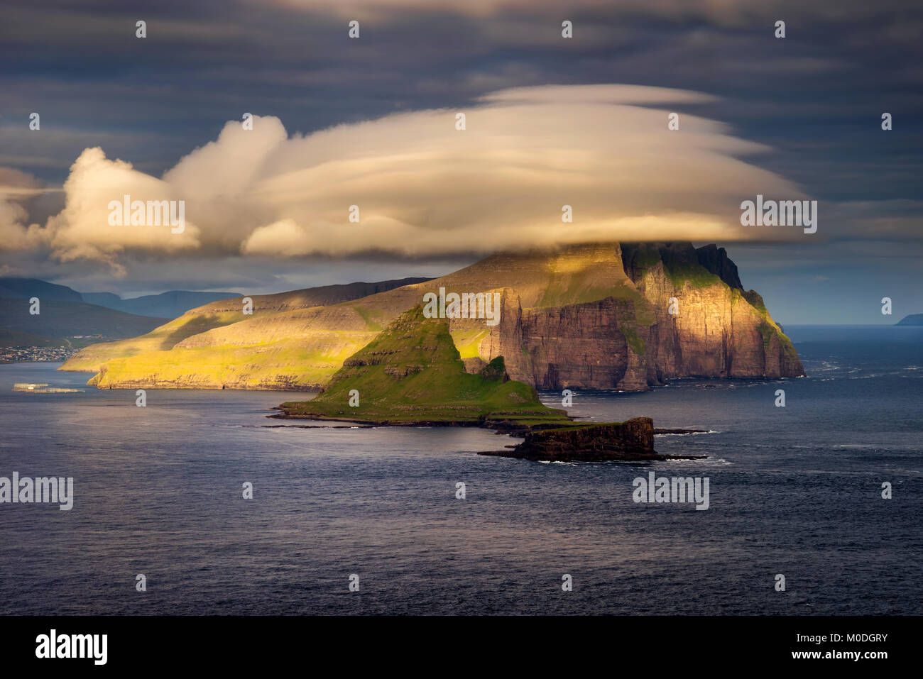 Amazing clouds over Tindholmur and Vagar islands in sunset light, Faroe ...