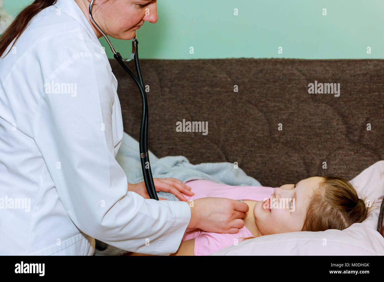 little-girl-at-the-doctor-health-professional-checking-her-with