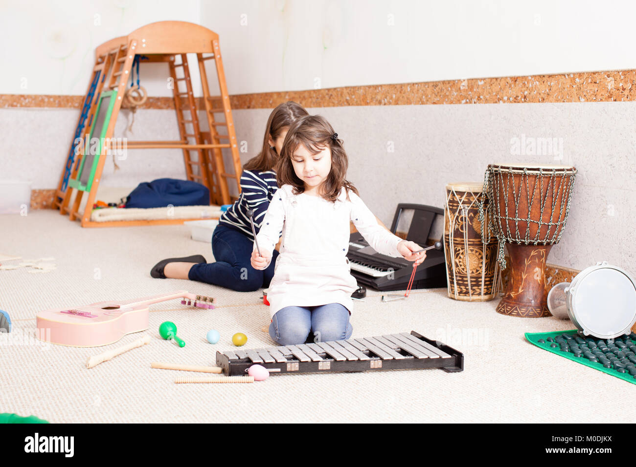 Cute girl playing on the xylophone Stock Photo