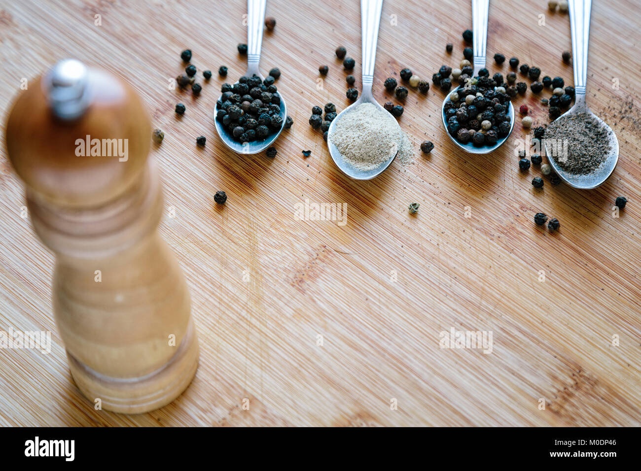 Various types of pepper on a wooden background Stock Photo